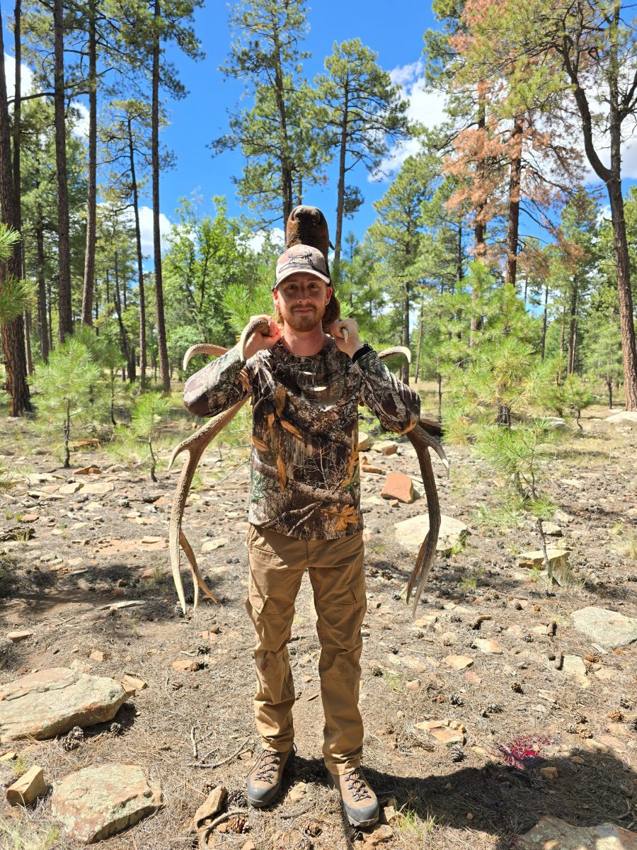 Matthew Osborn holding elk antlers after a hunt in Arizona
